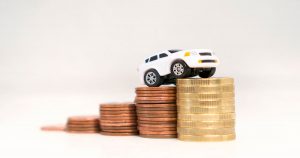 Miniature toy truck on top of stacked coins | Ellisville, MO 