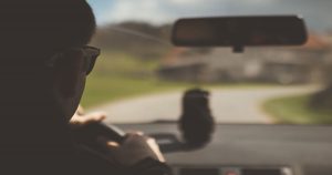 Interior view of a man driving a vehicle looking at the road | Ellisville, MO