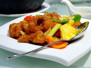 Sweet and sour pork on a white  plate. 