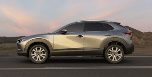 Profile view of a silver 2020 Mazda CX-30 parked on a highway. | Mazda dealer in Ellisville, MO