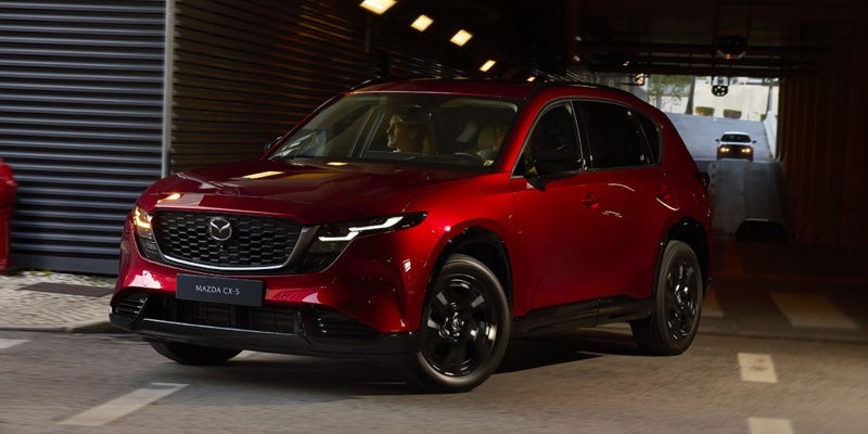 Red Mazda CX-5 compact SUV parked, showcasing its sleek design and modern features.